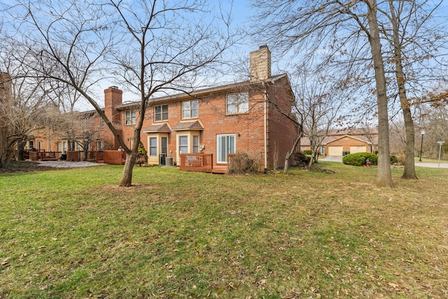 view of front of house featuring brick siding, a chimney, a deck, central AC, and a front yard