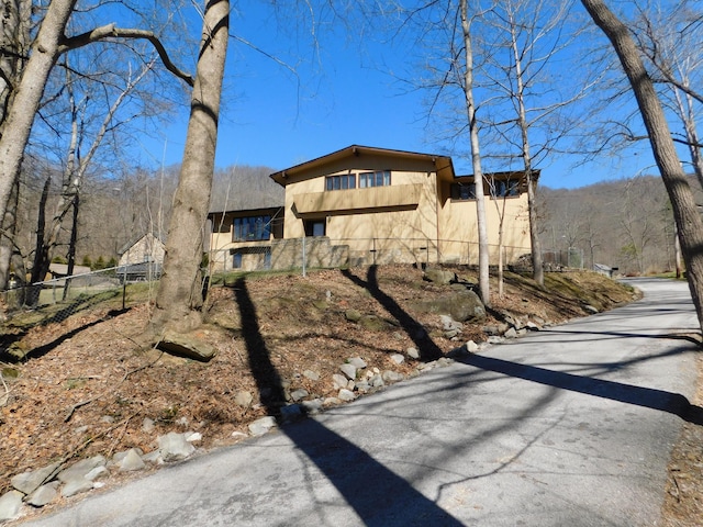 view of front of home featuring fence and stucco siding