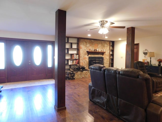 living area featuring a fireplace, wood finished floors, a ceiling fan, and recessed lighting