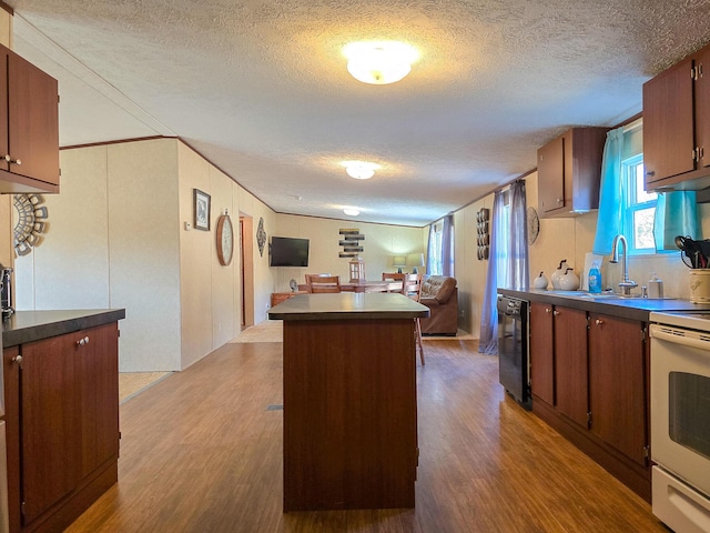 kitchen with open floor plan, white range with electric cooktop, a sink, and dark wood-style floors