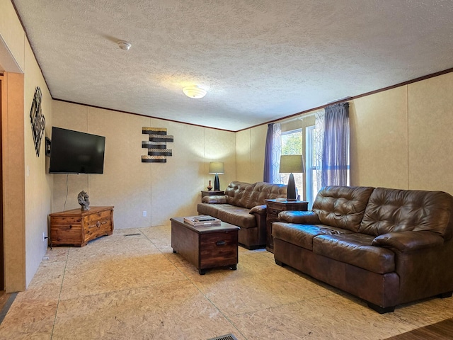 living room with crown molding and a textured ceiling