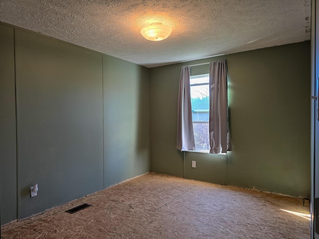 empty room featuring a textured ceiling and visible vents