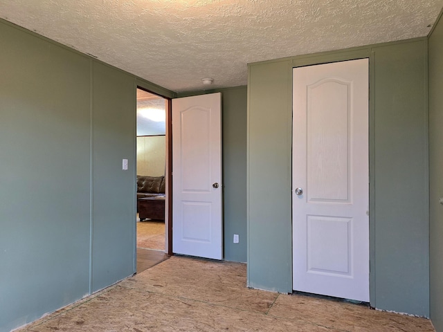 unfurnished bedroom with a textured ceiling