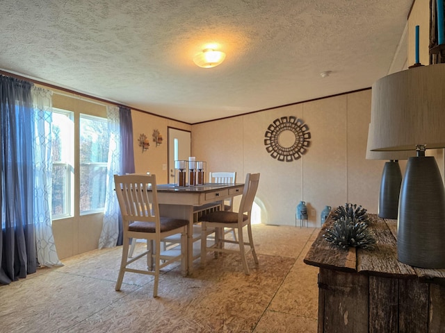 dining space featuring a textured ceiling