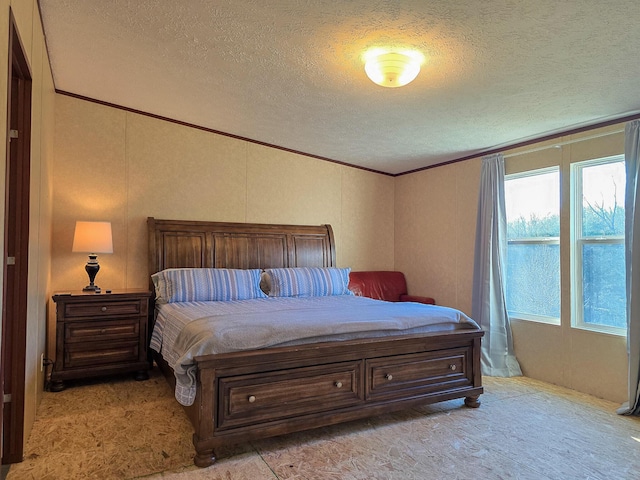 carpeted bedroom featuring ornamental molding and a textured ceiling