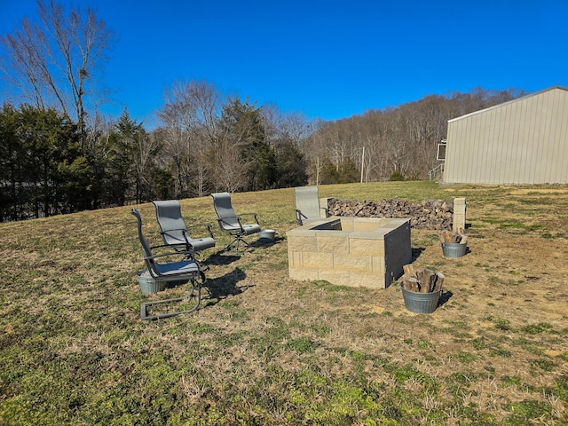 view of home's community with an outbuilding, a pole building, and a lawn