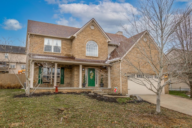 traditional-style home with brick siding, fence, driveway, a chimney, and a front yard