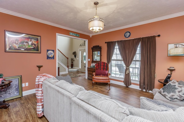 living area with ornamental molding, stairway, and wood finished floors