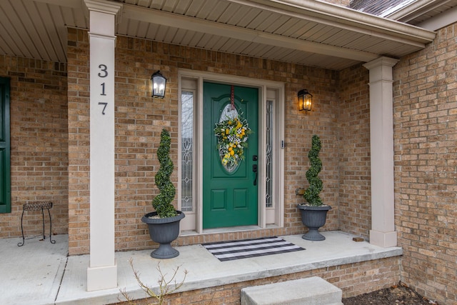 property entrance featuring brick siding