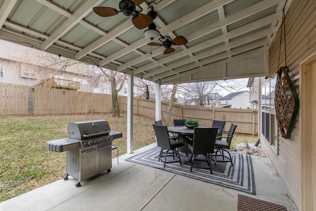 view of patio featuring outdoor dining area, a fenced backyard, ceiling fan, and grilling area