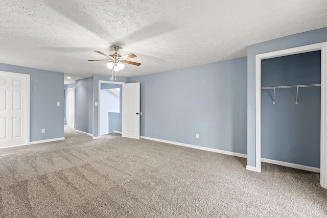 unfurnished bedroom featuring carpet, a closet, ceiling fan, a textured ceiling, and baseboards