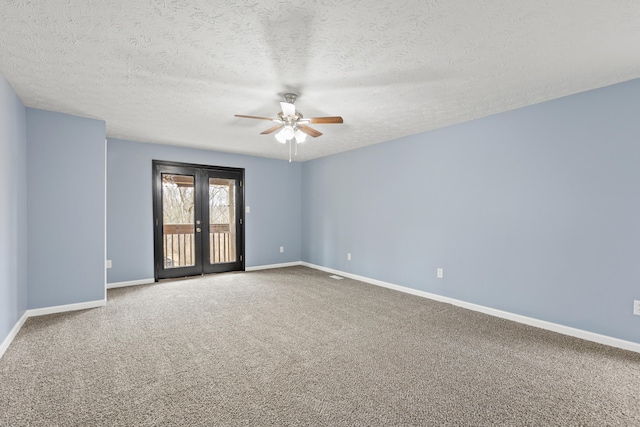 spare room featuring french doors, carpet flooring, ceiling fan, a textured ceiling, and baseboards