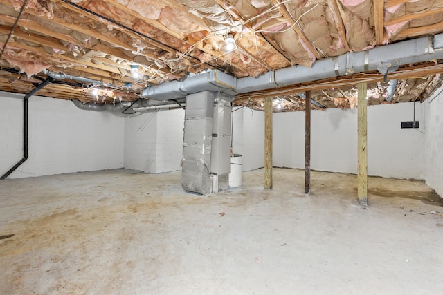 unfinished below grade area featuring heating unit