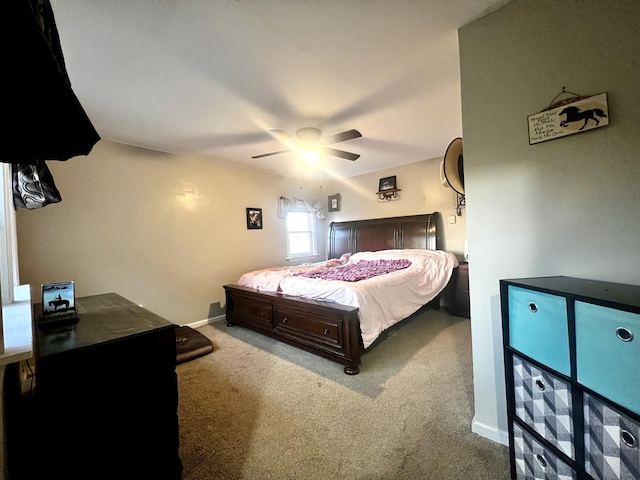 bedroom featuring carpet floors, a ceiling fan, and baseboards