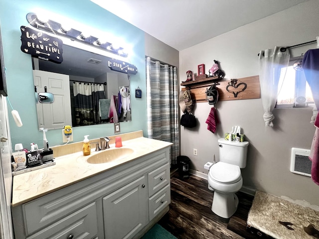 full bathroom featuring visible vents, toilet, vanity, wood finished floors, and baseboards