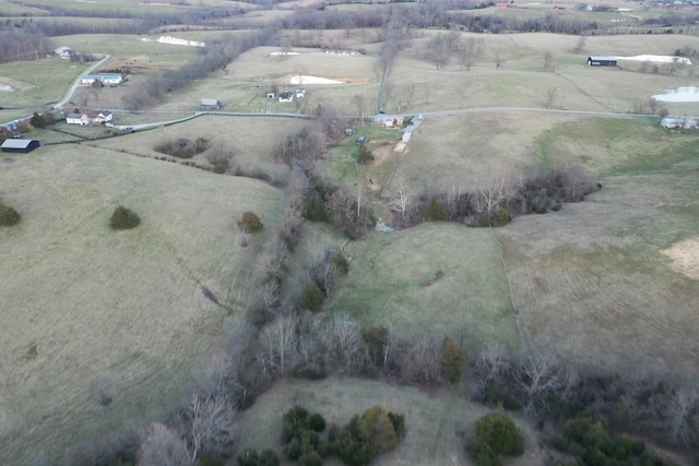 birds eye view of property with a rural view