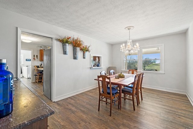 dining area with baseboards, a textured ceiling, dark wood finished floors, and an inviting chandelier