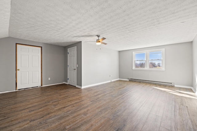 unfurnished living room with dark wood-style floors, baseboards, baseboard heating, and a textured ceiling