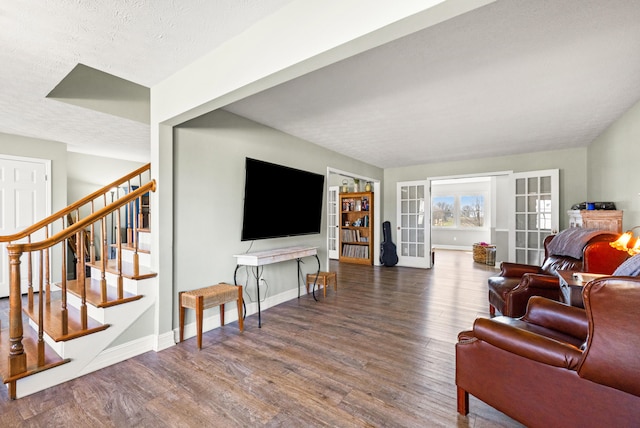 living room featuring stairs, baseboards, wood finished floors, and french doors