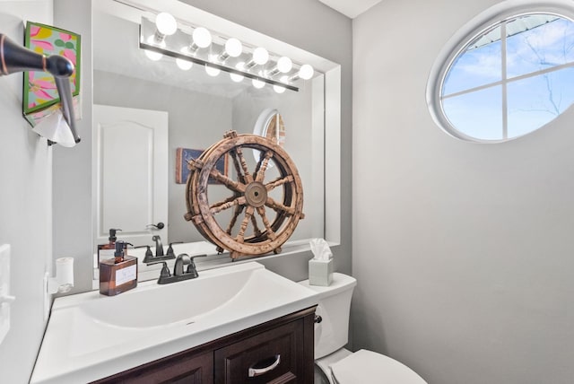 bathroom featuring toilet and vanity