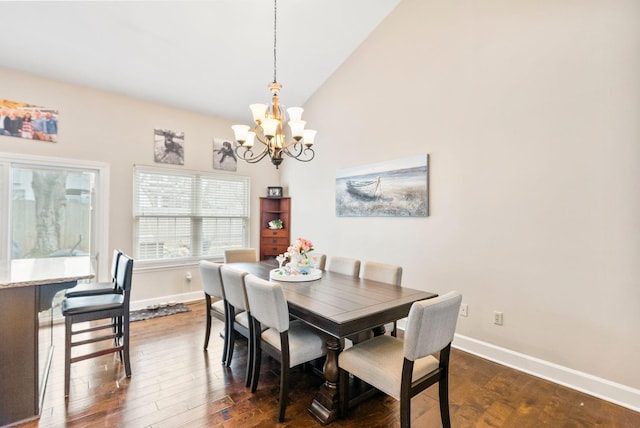 dining space featuring dark wood finished floors, high vaulted ceiling, baseboards, and a chandelier