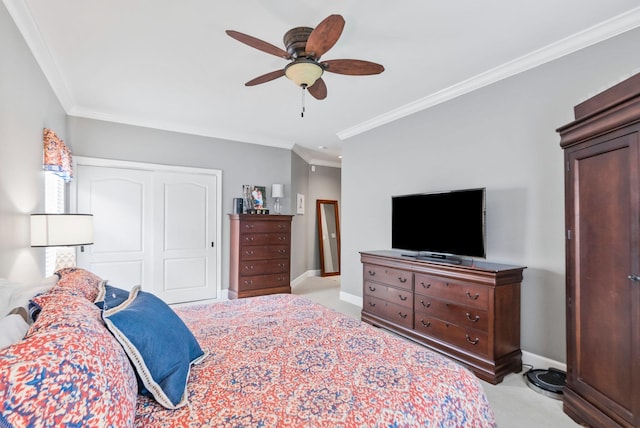 bedroom with ornamental molding, light colored carpet, a closet, and baseboards