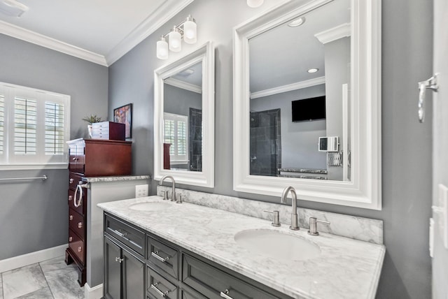 full bath featuring double vanity, ornamental molding, baseboards, and a sink