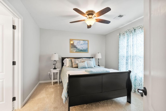 bedroom with ceiling fan, baseboards, visible vents, and light carpet