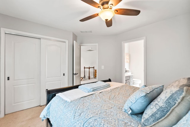 bedroom with visible vents, light carpet, ensuite bath, a closet, and ceiling fan