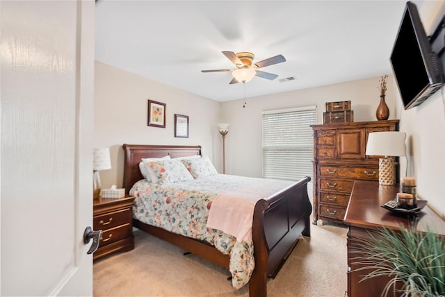 carpeted bedroom featuring visible vents and ceiling fan