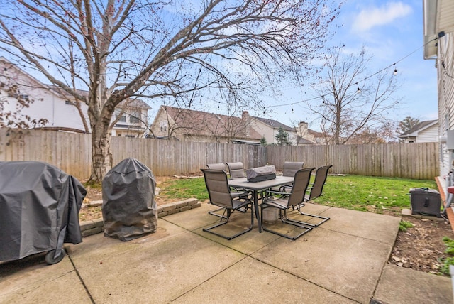 view of patio / terrace with outdoor dining space, a grill, and a fenced backyard