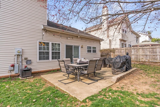 back of property with a patio area and fence