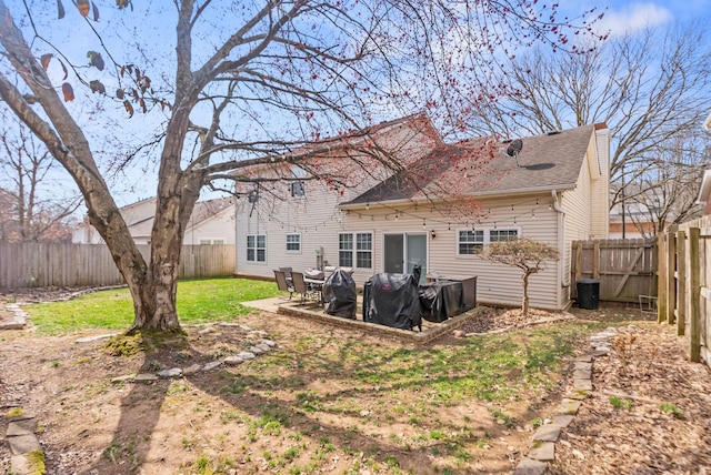 back of house with a patio, a yard, and a fenced backyard