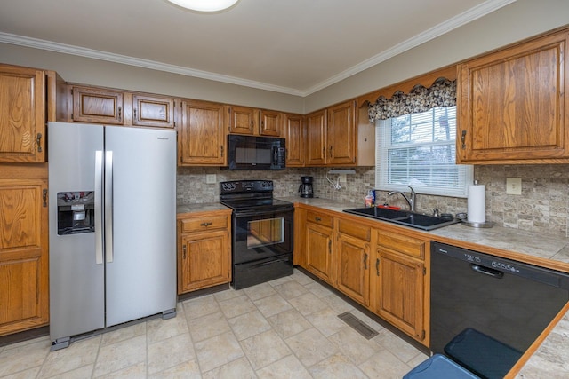 kitchen with brown cabinets, a sink, and black appliances