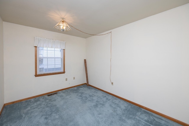 carpeted empty room with visible vents and baseboards