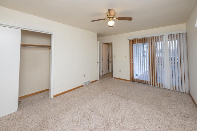 unfurnished bedroom featuring a closet, visible vents, carpet flooring, ceiling fan, and baseboards