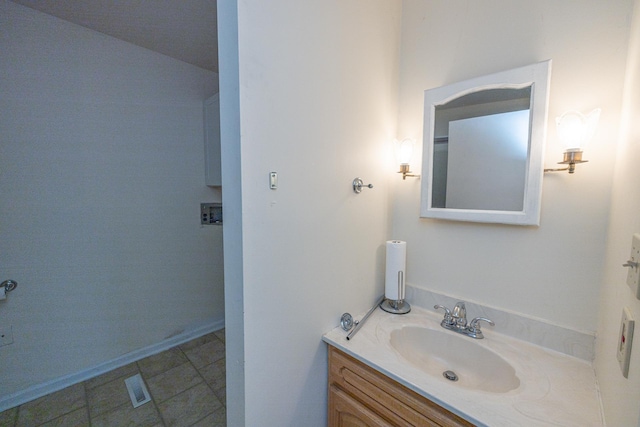 bathroom featuring tile patterned floors, vanity, and baseboards