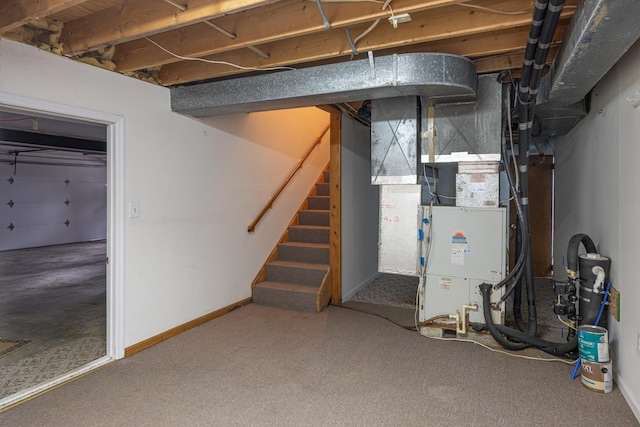 unfinished below grade area featuring stairs and baseboards