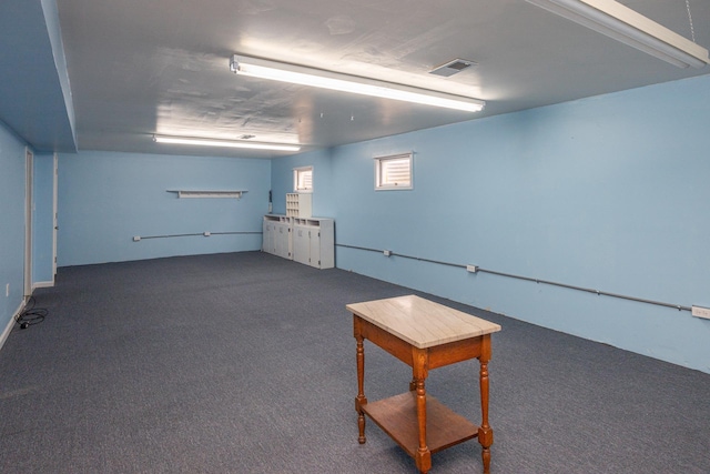 interior space with carpet floors and visible vents