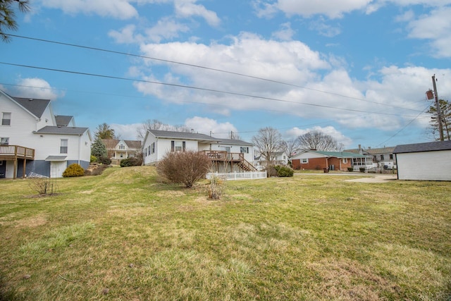 view of yard with a residential view and a wooden deck