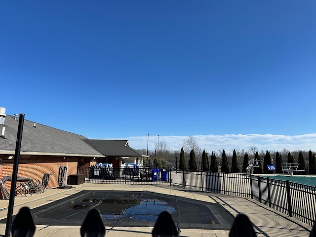 community pool featuring a patio and fence