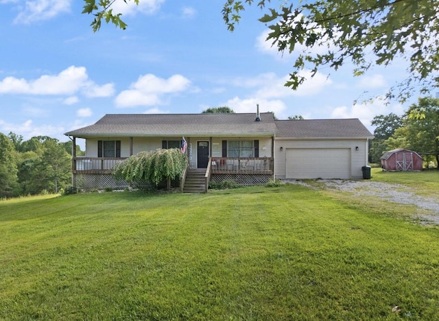 single story home featuring a storage shed, driveway, a front yard, and an attached garage