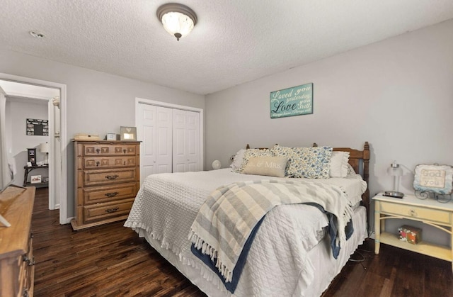 bedroom with a textured ceiling, a closet, and wood finished floors