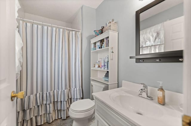 bathroom with curtained shower, vanity, and toilet