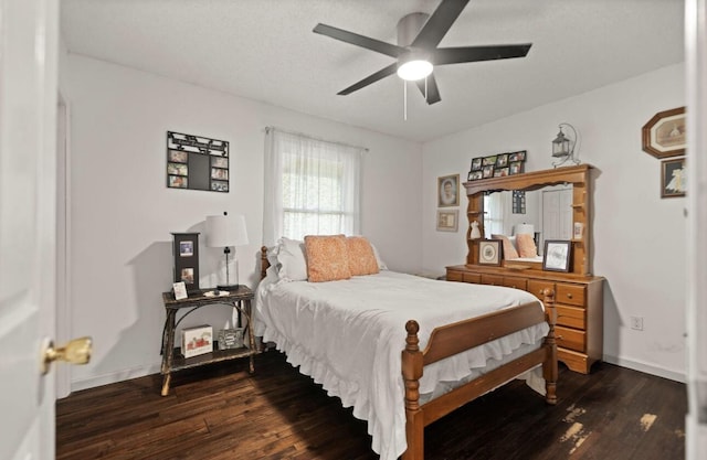 bedroom with dark wood-style flooring, ceiling fan, and baseboards