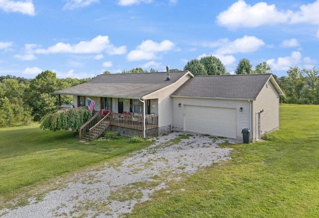 ranch-style house with a shingled roof, covered porch, a garage, driveway, and a front lawn