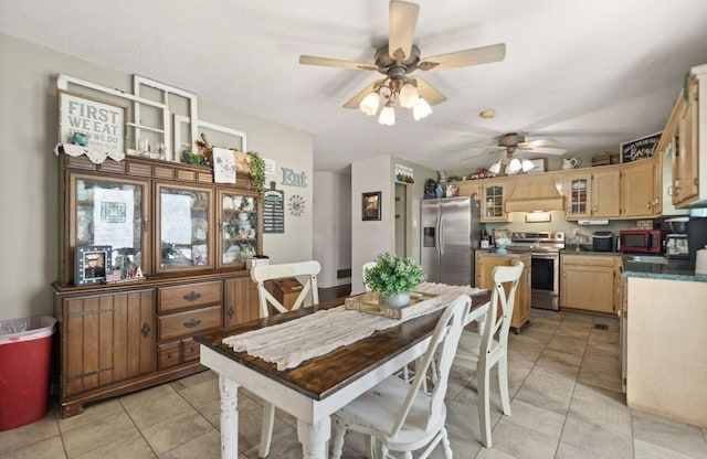 dining room featuring light tile patterned floors and a ceiling fan