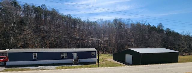 exterior space with a forest view