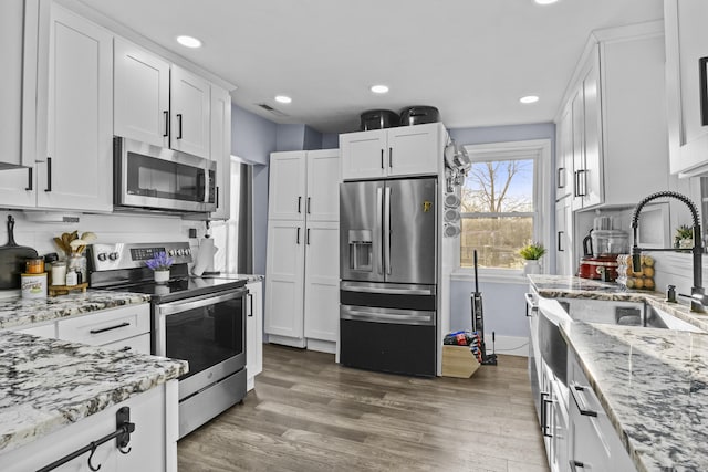 4200 Grays Run Pike, Cynthiana, KY 41031 - kitchen with visible vents, light stone countertops, stainless steel appliances, wood finished floors, and white cabinetry