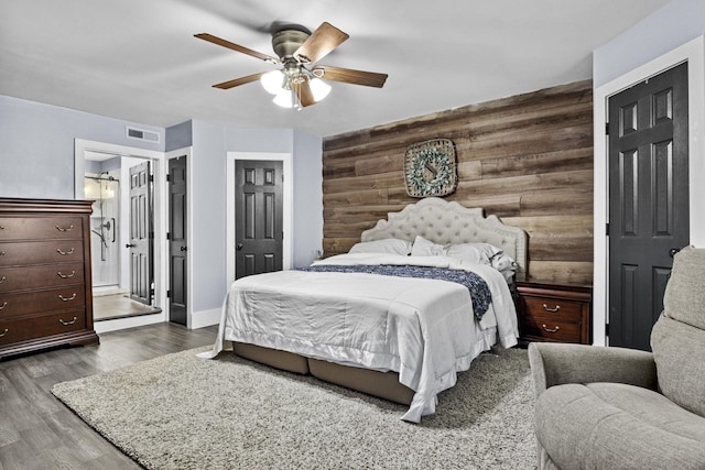 4200 Grays Run Pike, Cynthiana, KY 41031 - bedroom featuring visible vents, wooden walls, dark wood-type flooring, ceiling fan, and an accent wall